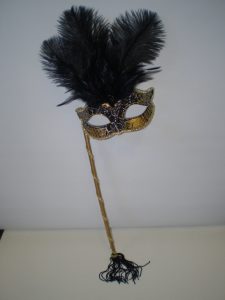 Black & gold masquerade mask on stick