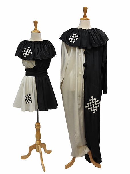 Dress forms wearing black and white harlequin clown costumes for male and female