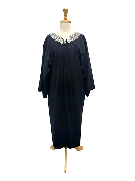 Image shows a mannequin wearing a black Judges robe with an attached lace collar, suitable for judge Judy or Ruth Bader Ginsburg