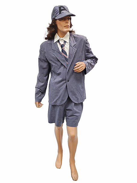 Image shows an Angus Young costume. It is gray velvet school boy uniform available to hire from Acting the Part in Sydney, Australia