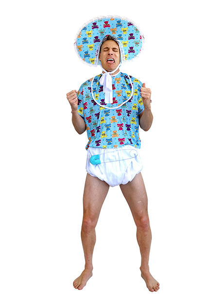 Image shows an adult dressed as a baby. Costume available to purchase from Acting the Part in Carlingford, Sydney. Includes a blue patterned bonnet, bib, t shirt & a white nappy with an oversize safety pin.