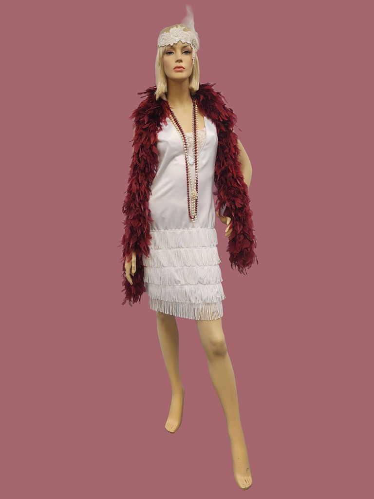 White 1920s dress worn with a burgundy feather boa.