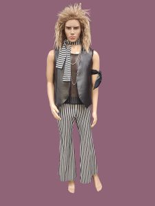 Men's Glam Rock outfit includes stripe flares, mesh top, blond crimped wig & leather look vest. Available to hire in Sydney