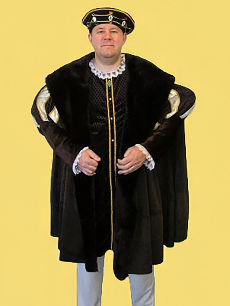 A man dressed in a regal historical costume with a brown fur cloak and a jeweled hat, set against a yellow background, Suitable for Henry VIII a Tudor King