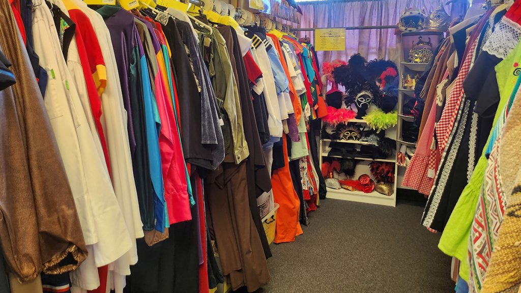 Costume shop rack showing western costumes and uniforms