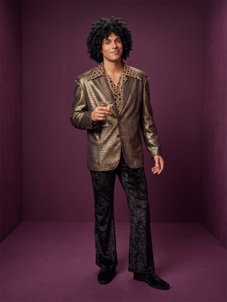 Men's 1970s disco outfit including gold jacket, brown pattern wide collared shirt and black velvet flares